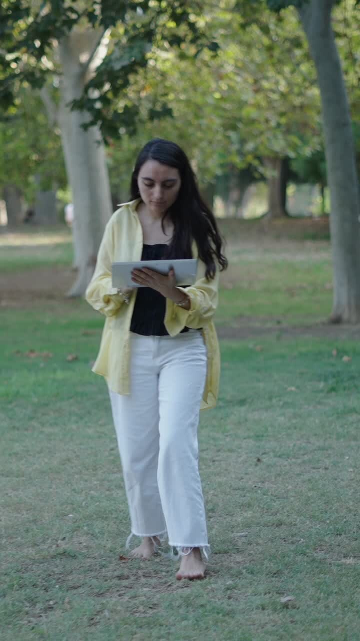 Woman using tablet in park