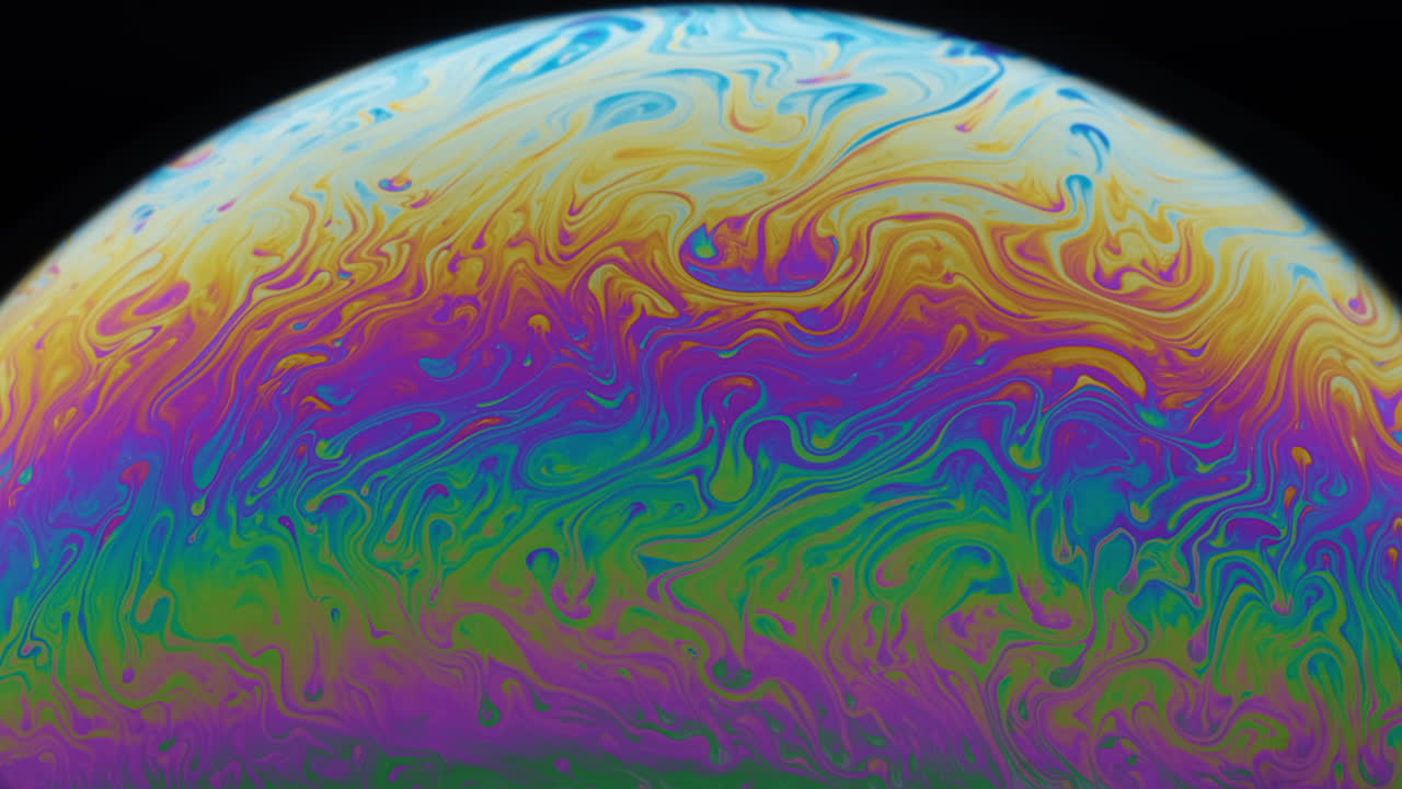 Close-up footage of the colourful surface of a soap bubble