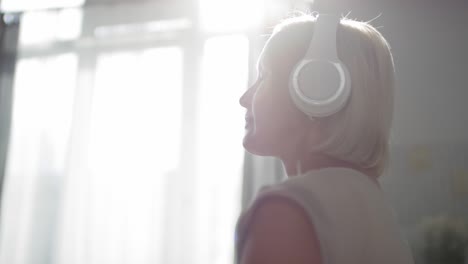 woman in headphones enjoying relaxing music with eyes closed