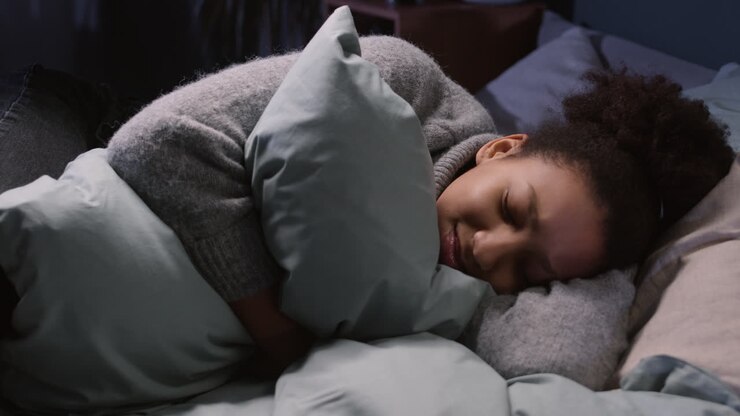 Young woman hugging a pillow
