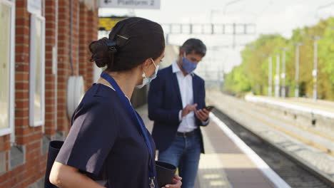 Nurse-On-Railway-Platform-Wearing-PPE-Face-Mask-Commuting-To-Work-During-Pandemic