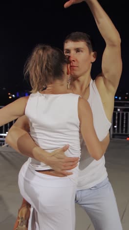 couple dancing romantically on a rooftop at night
