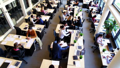 busy office environment with employees working at desks
