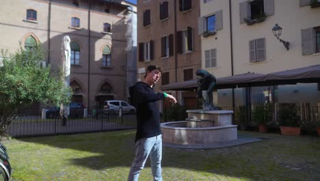 young man posing in a european city plaza