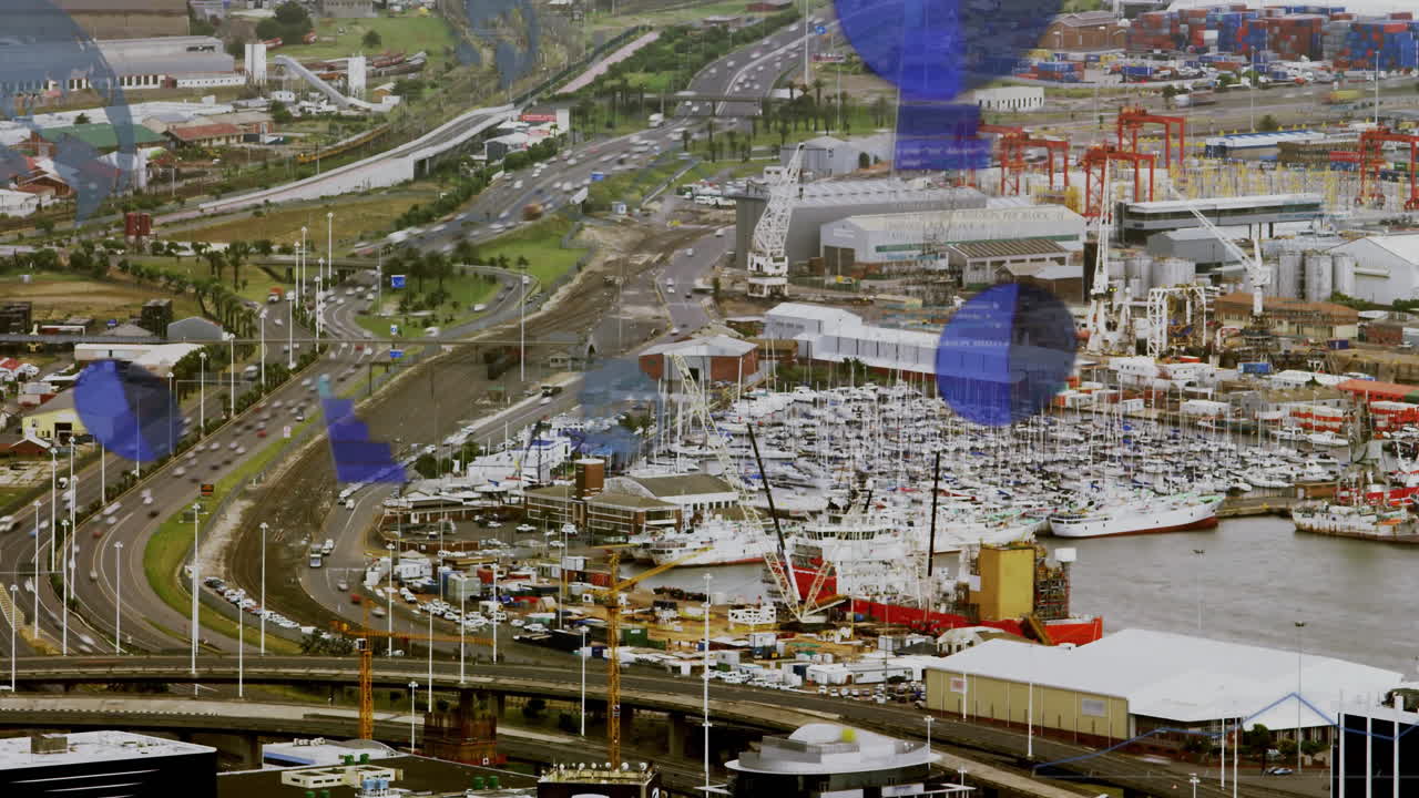 Cityscape with busy roads and harbor, blue geometric shapes animation over scene