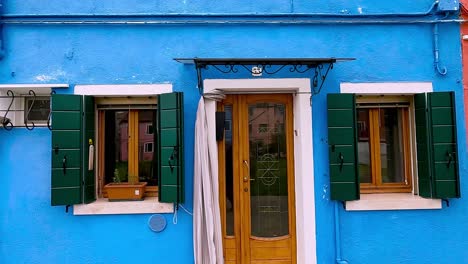 sideways view of burano colorful houses in venetian lagoon, in italy