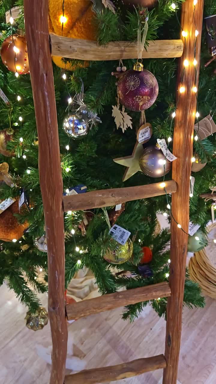 Vertical shot rising along a decorated artificial Christmas tree in store
