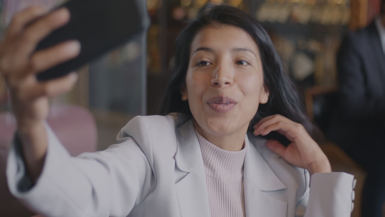 Businesswoman taking a selfie in a cafe
