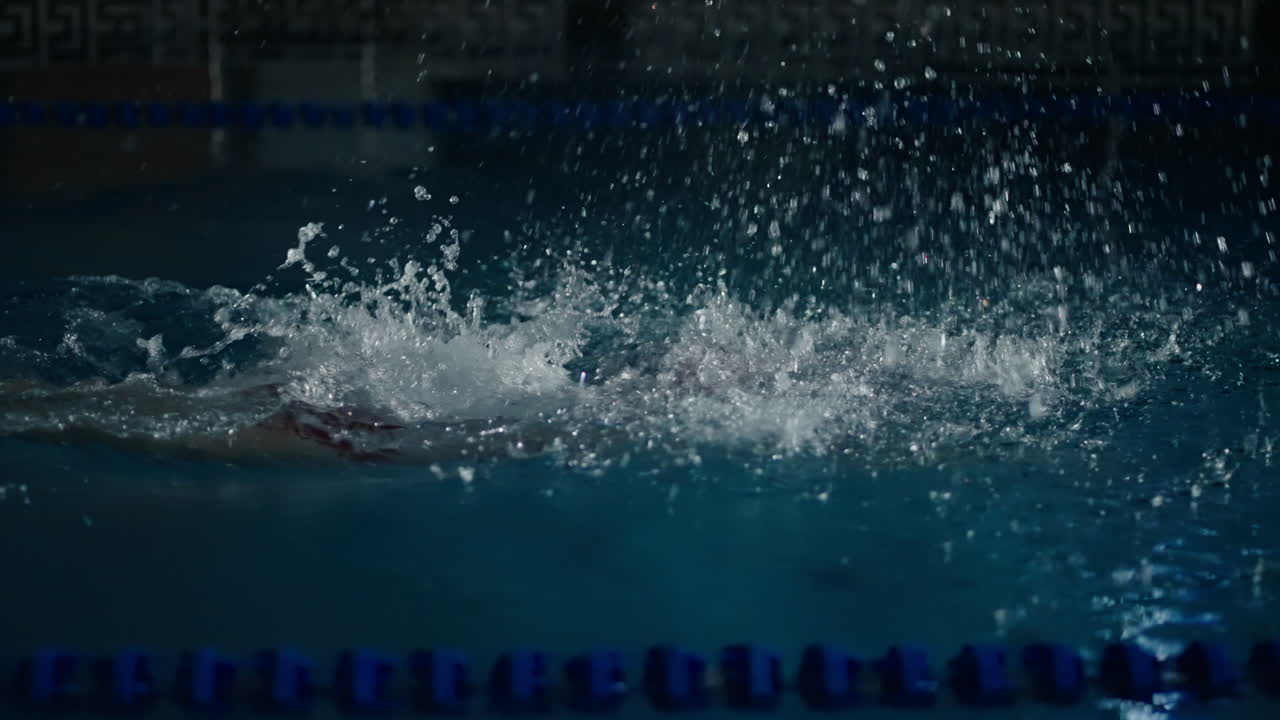 Woman Swimming Freestyle in Pool