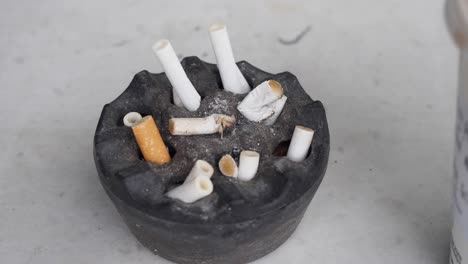 used cigarette butts in ashtray