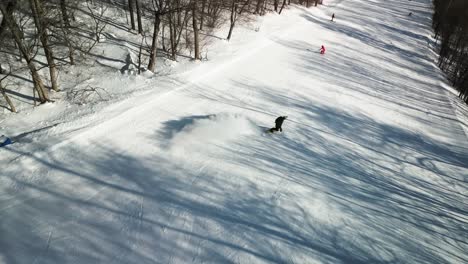 The-aerial-footage-showcases-a-young-snowboarder-skillfully-riding-down-the-slopes-of-Yabuli-resort