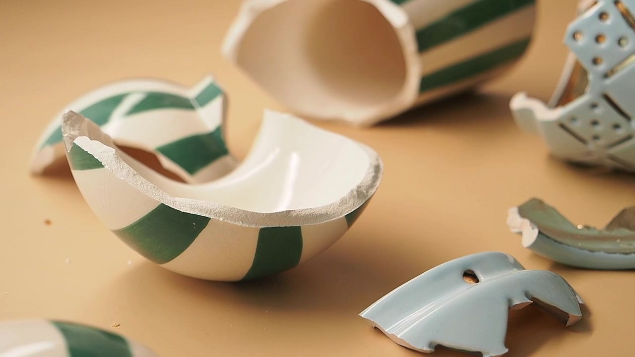 Broken Ceramic Pieces and Shattered Pottery on a Table