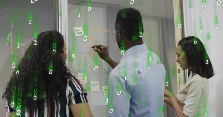 Coworkers picking up colored markers mapping user journey on glass whiteboard in business meeting