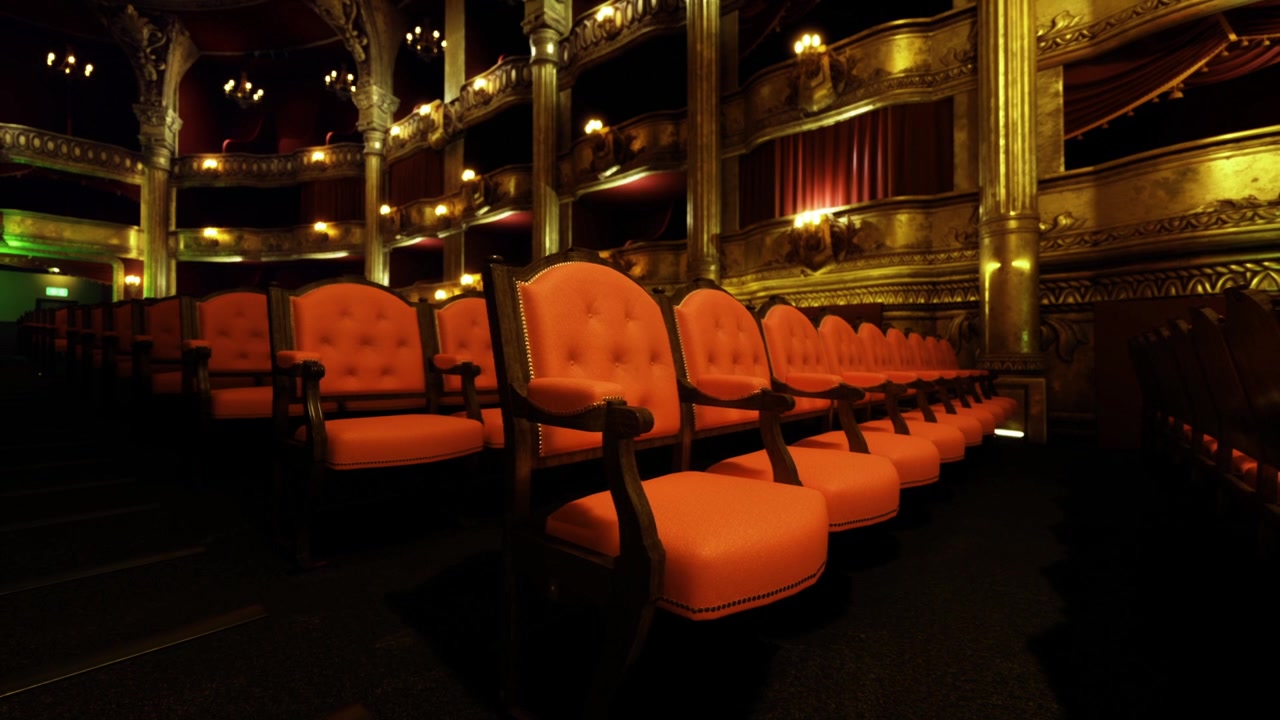 Silent theater rehearsal hushed auditorium with soft amber lighting