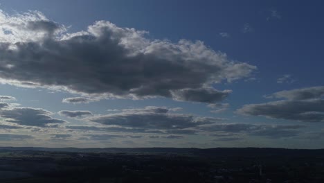 white and dark fluffy clouds with a blue sky