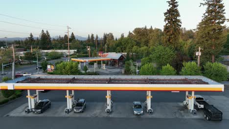 Car-pulling-into-a-large-gas-station-during-the-evening