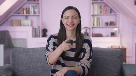 happy indian girl watching tv
