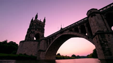 historic stone bridge over river at dusk