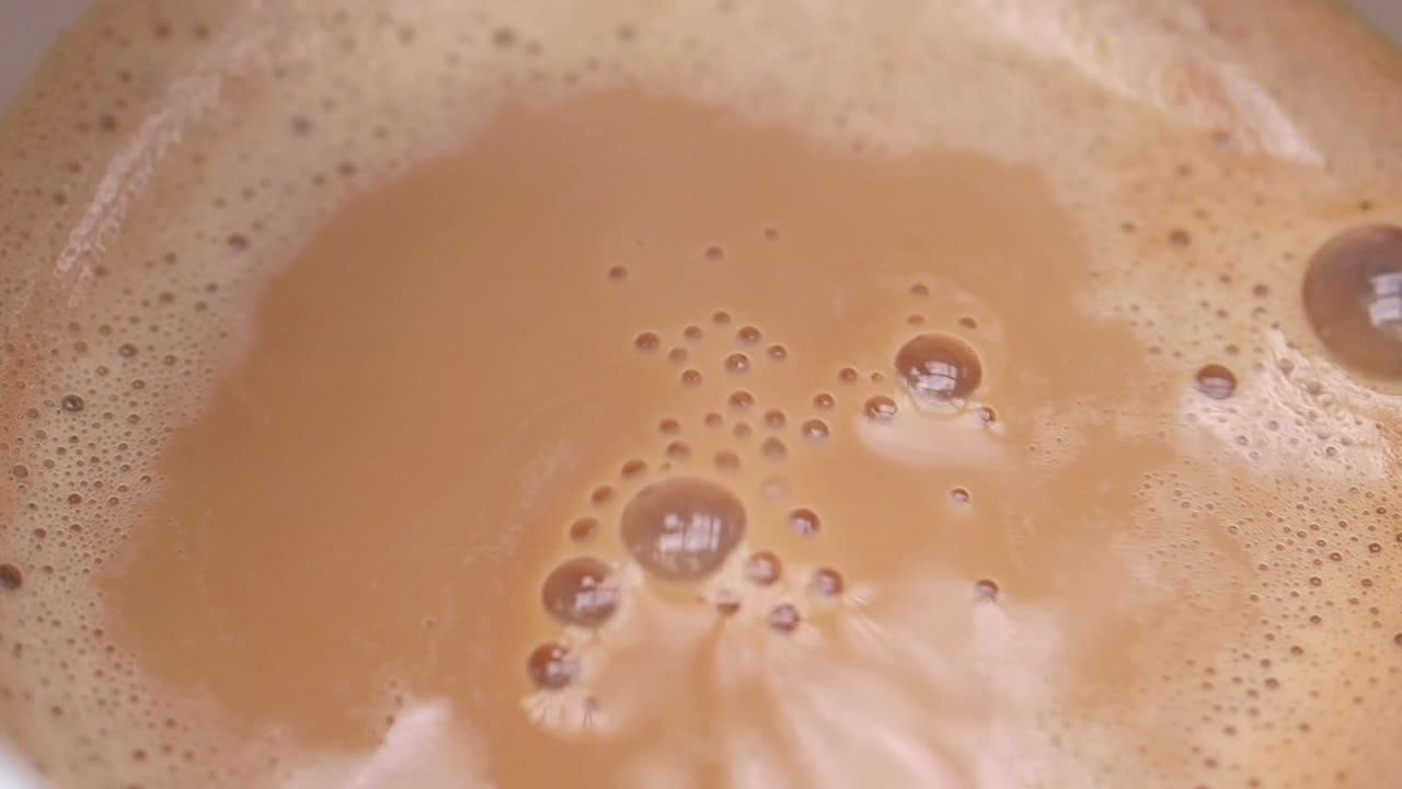 Close-up of a cup of coffee or tea with foam