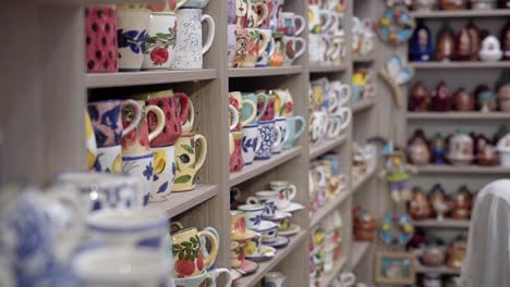 handmade ceramic tea cups and coffee mugs at a small shop, agiasos village, mytilene, lesvos, gimbal shot