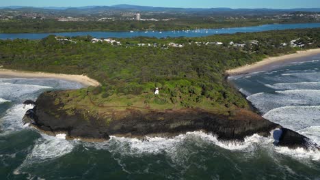 reversing aerial over fingal head towards with the gold coast hinterland in the background, northern new south wales, australia