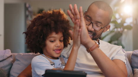 father and daughter enjoying quality time together using a tablet