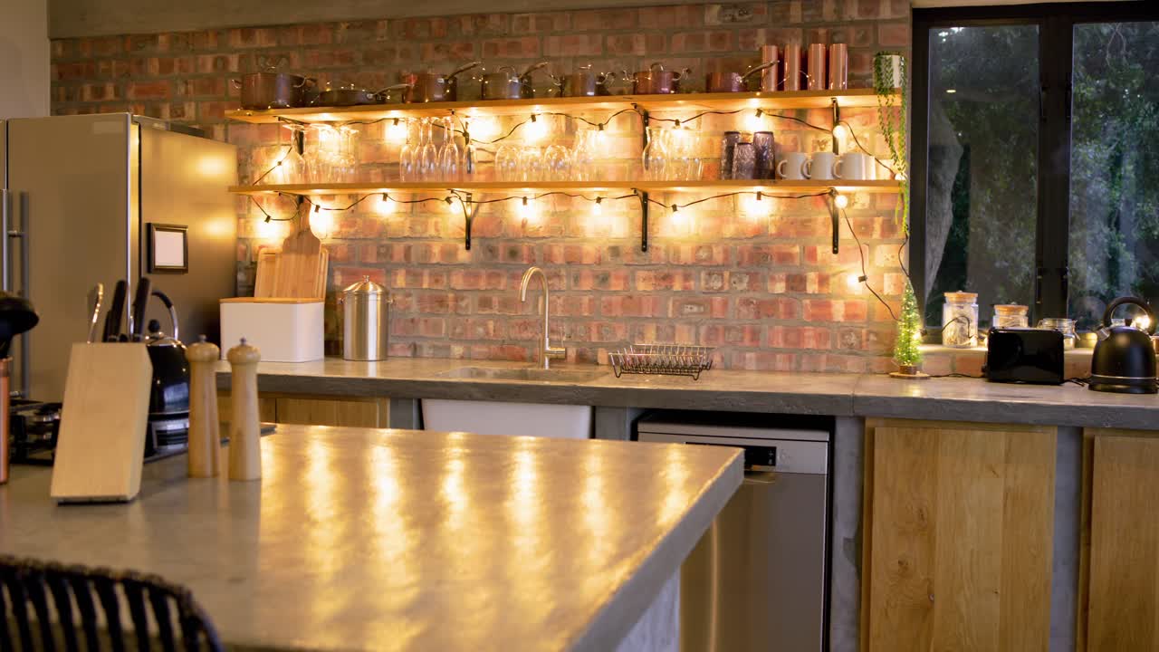 Camera panning across kitchen island with copper utensils and pepper mills, showcasing garden view