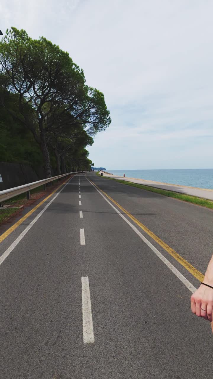 Athlete young Female Rollerblading on Coastal Path. Vertical