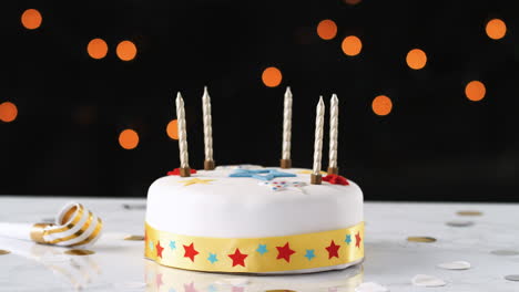 jump cut, stop frame animation, of seven candles appearing and disappearing from a birthday cake, a party blower beside it, bokeh lights in the background