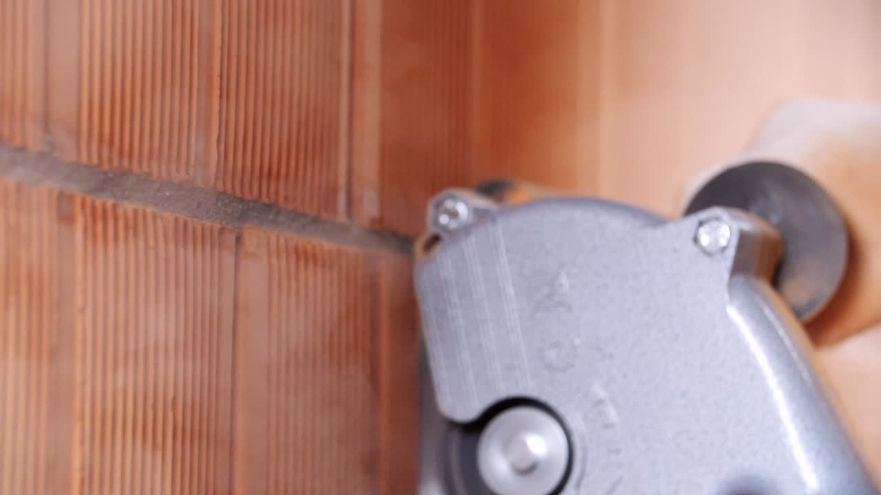 전력 도구 로 벽돌 벽 을 자르는 것