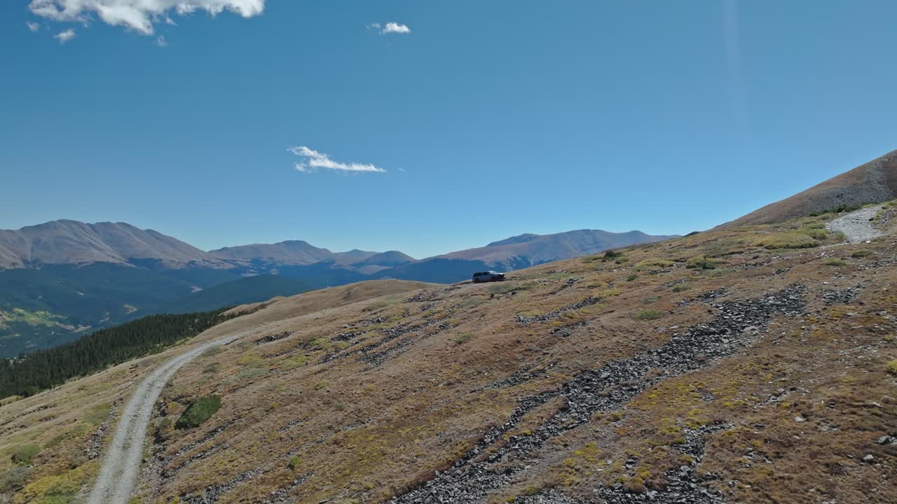SUV Driving on a Mountain Dirt Road