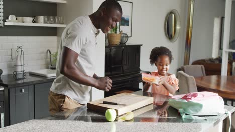 video of african american father and daughter preparing breakfast
