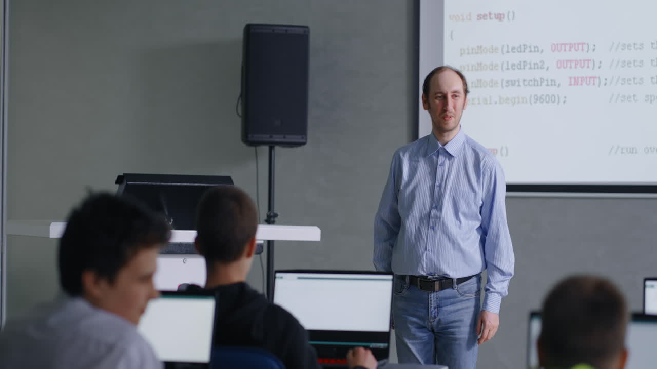 Teacher Presenting Programming Concepts in a Classroom