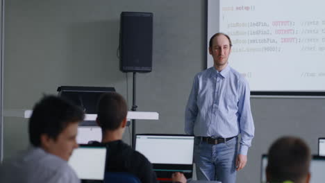 teacher presenting programming concepts in a classroom