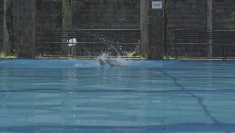 young man swimmer in the pool swims style crawl