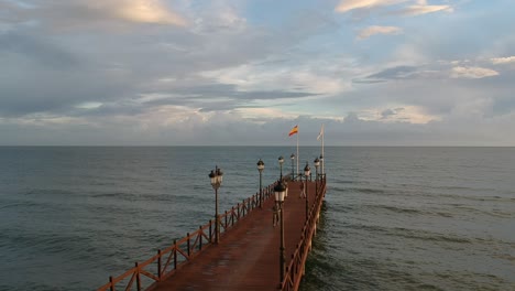 Wooden-jetty-on-the-Mediterranean-sea-with-people-walking-on-it