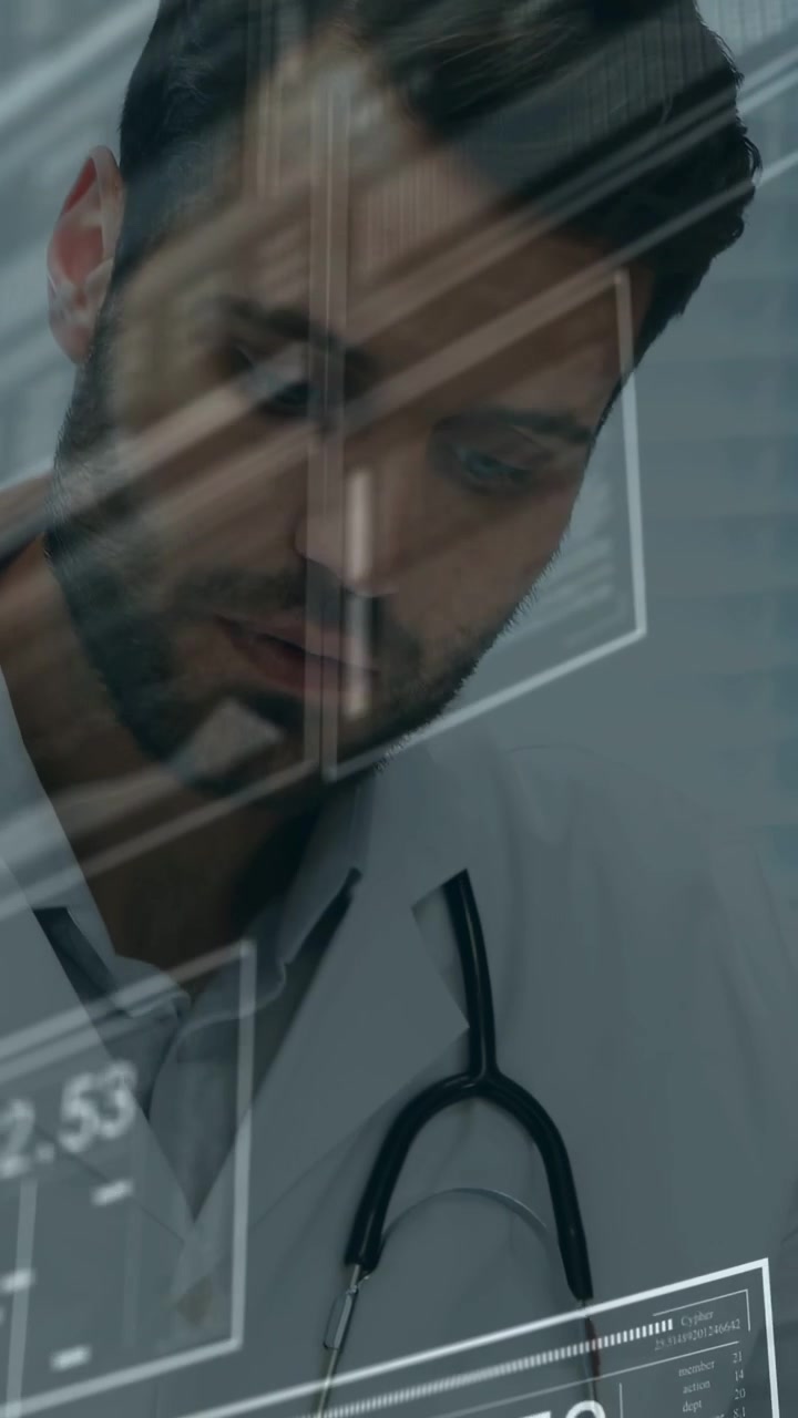 Vertical video: Doctor updating chart with stethoscope hanging as medical data overlay appearing