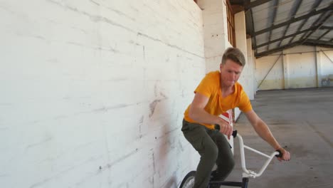 bmx rider in an empty warehouse