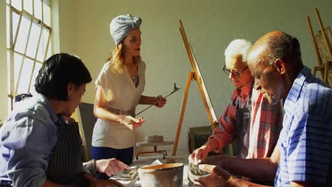 woman assisting artists in pottery 4k