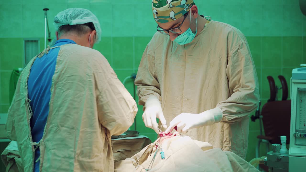 Public hospital. Surgeons team performing operation in hospital operating theater.