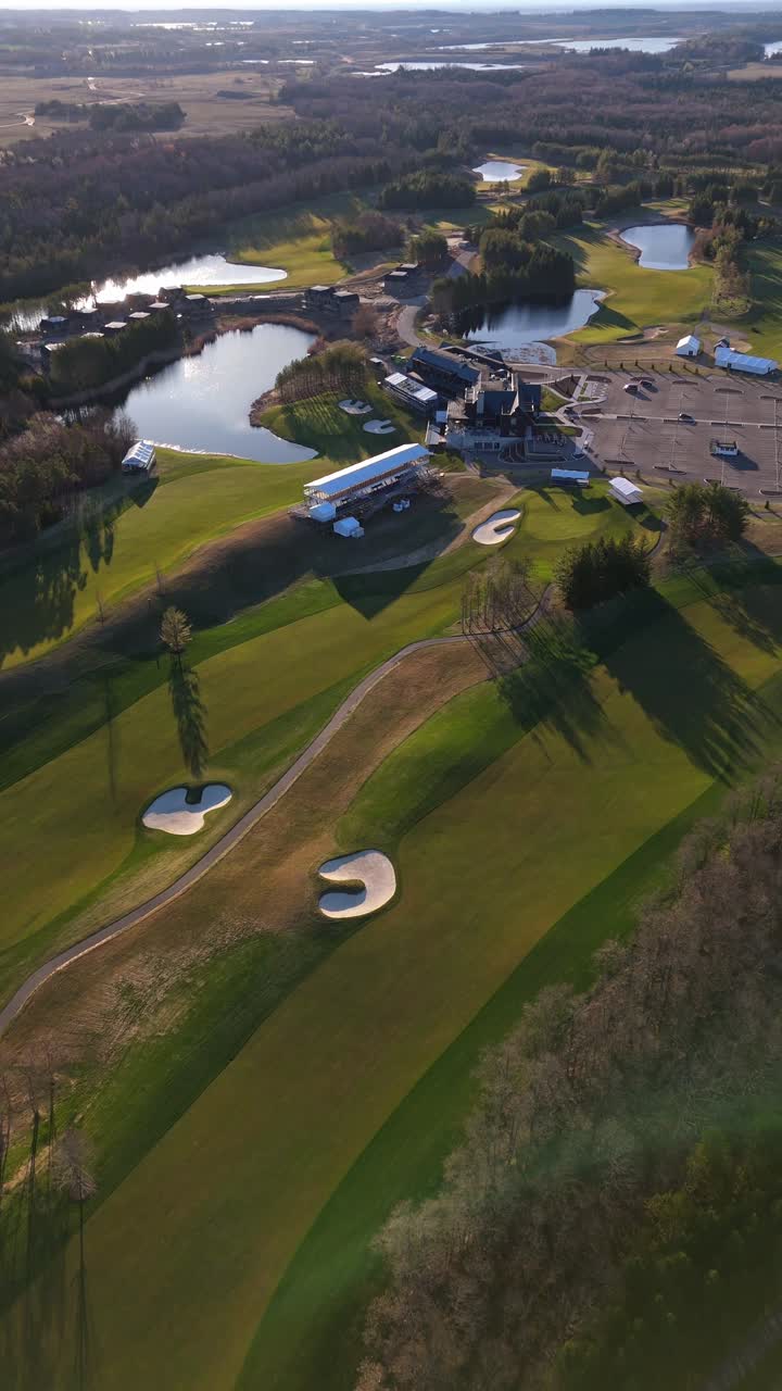 Vertical, pull out drone shot of TPC Toronto at Osprey Valley Golf Course during the day in Alton, Caledon, Ontario, Canada