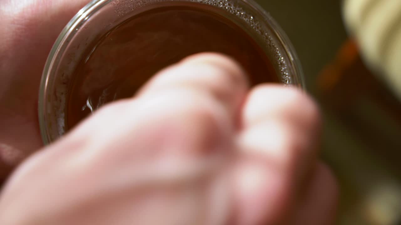 Stirring freshly prepared mint tea. Close up, top shot, real time.