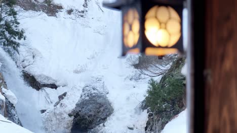 Revealing-a-Waterfall-in-Snow,-Ginzan-Onsen,h-Japan,-Pan-shot