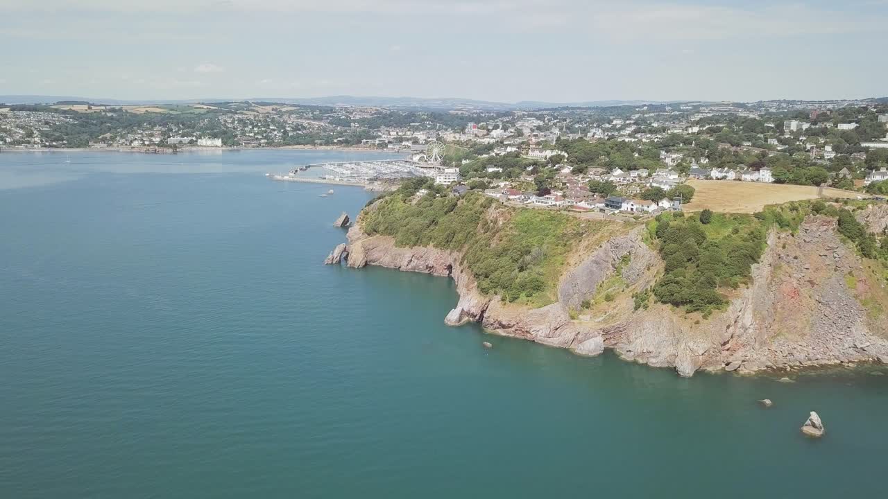 Aerial view of a coastline with a cityscape in the background