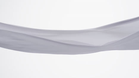 animation of white fabric blowing with copy space over white background