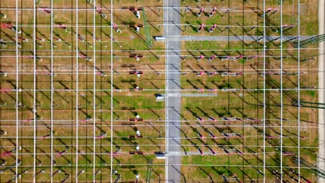 bird's eye view over high voltage substation in summer - drone shot