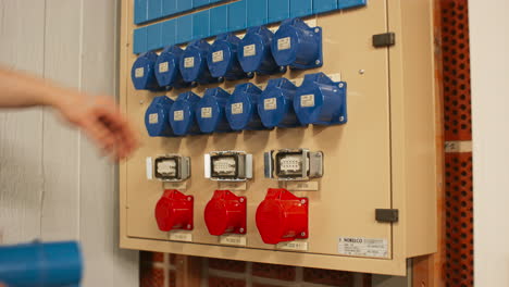 electrical panel with blue 16a and red 32a three phase connectors and distribution box