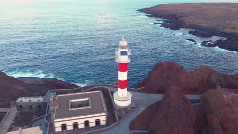 lighthouse building in tenerife with majestic ocean view, aerial drone shot