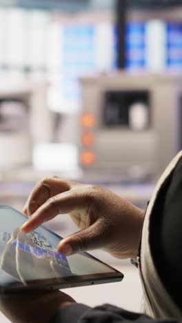 vertical video close up of engineer in industry 4.0 plant designing robotic production lines
