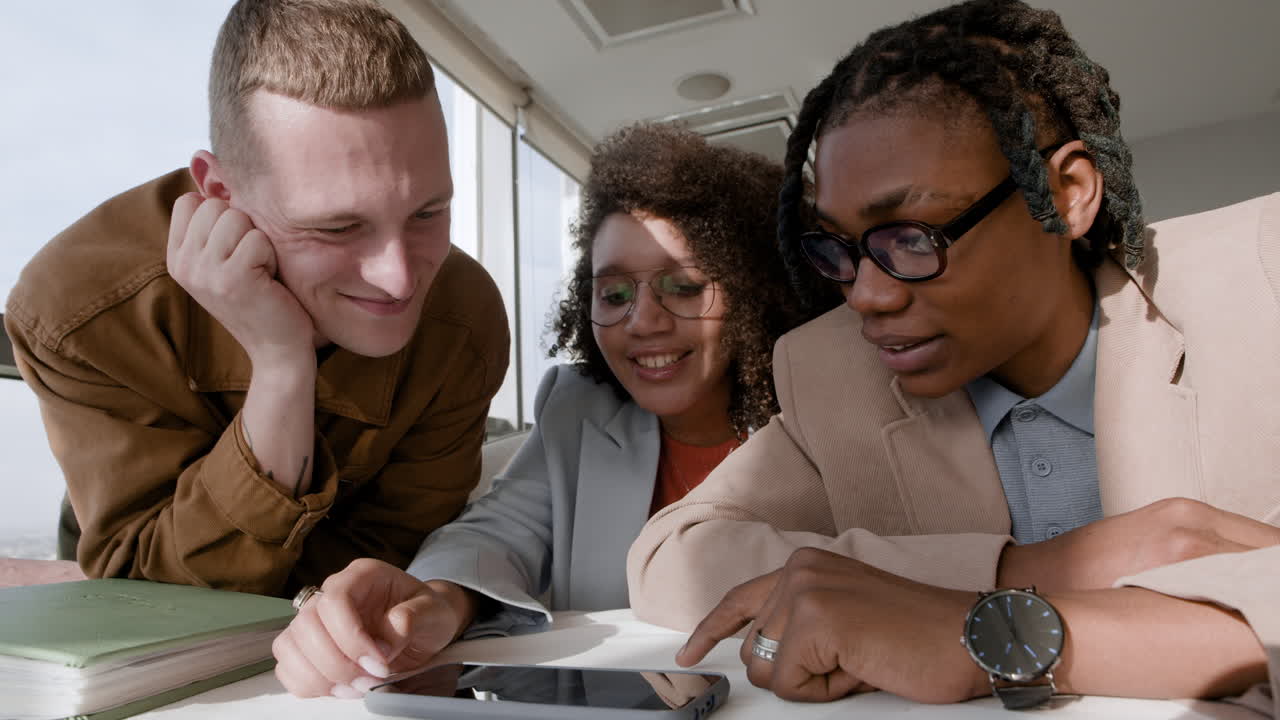 Business Team Discussing Project on Tablet
